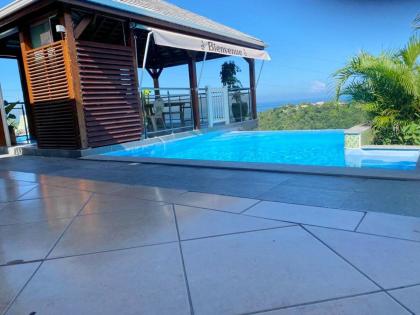 Bungalow de 2 chambres avec vue sur la mer piscine partagee et jardin clos a Vieux Habitants a 6 km de la plage - image 24